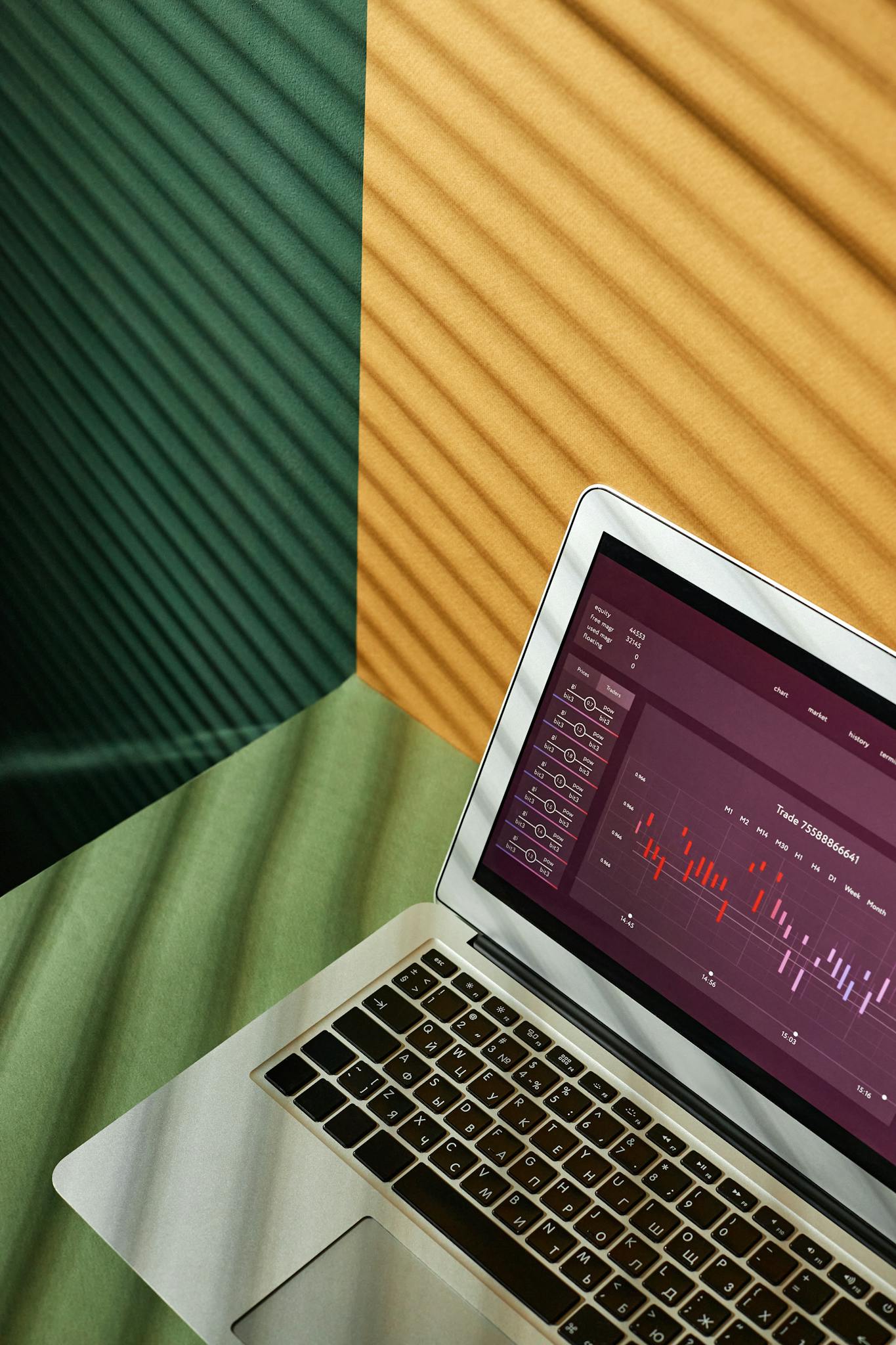 A close-up of a laptop displaying data visualization on a colorful background.